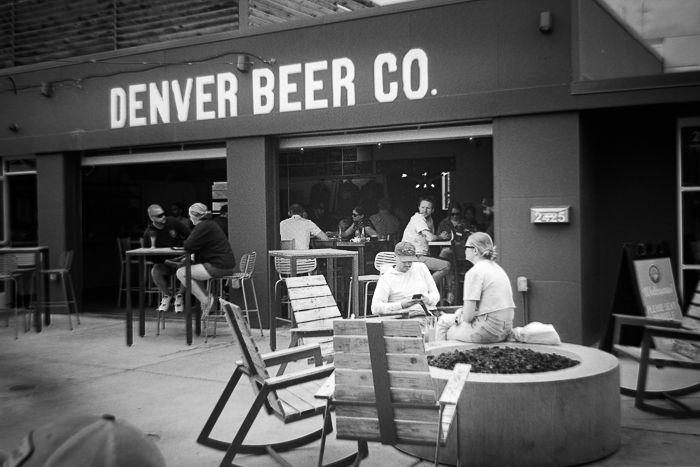 a couple ignoring each other near the fire pit at Denver Beer Co.