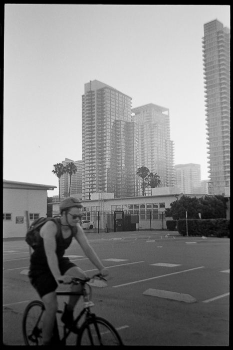 skyscrapers behind a cyclist